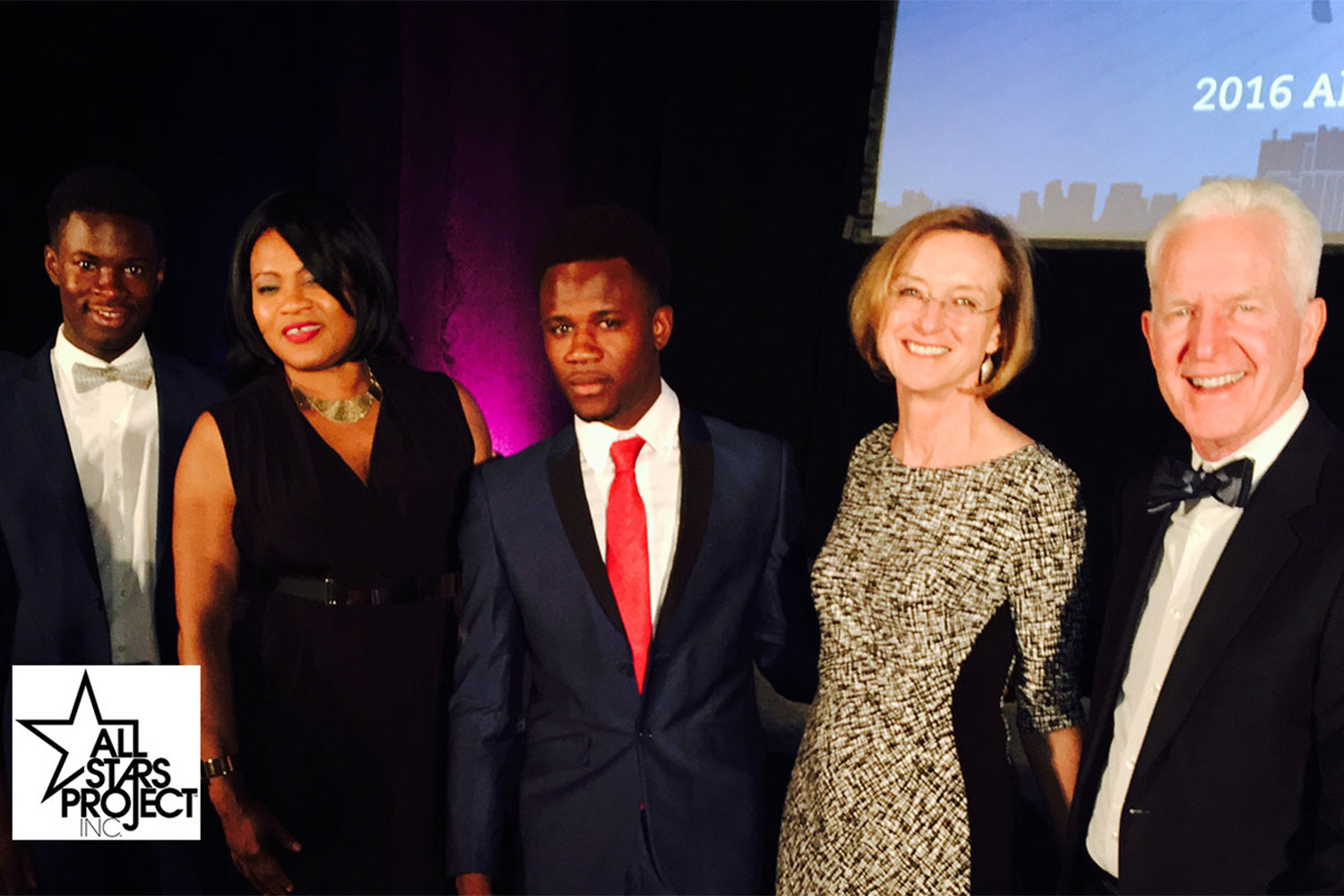 five people posing at rewards ceremony 