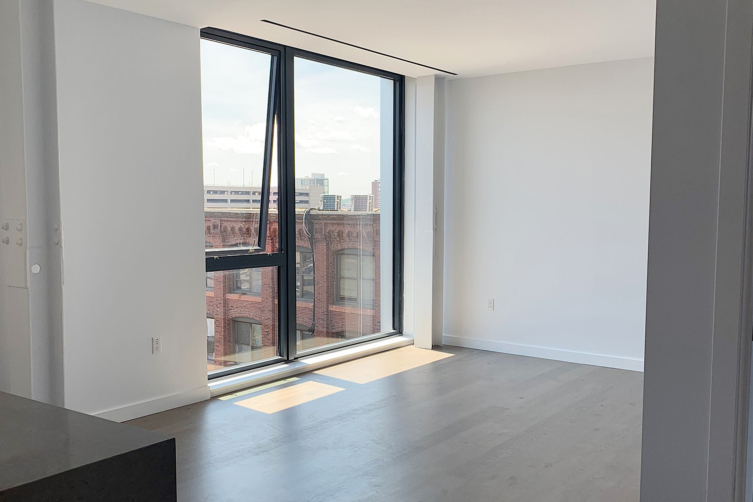 Spacious living area with large window 