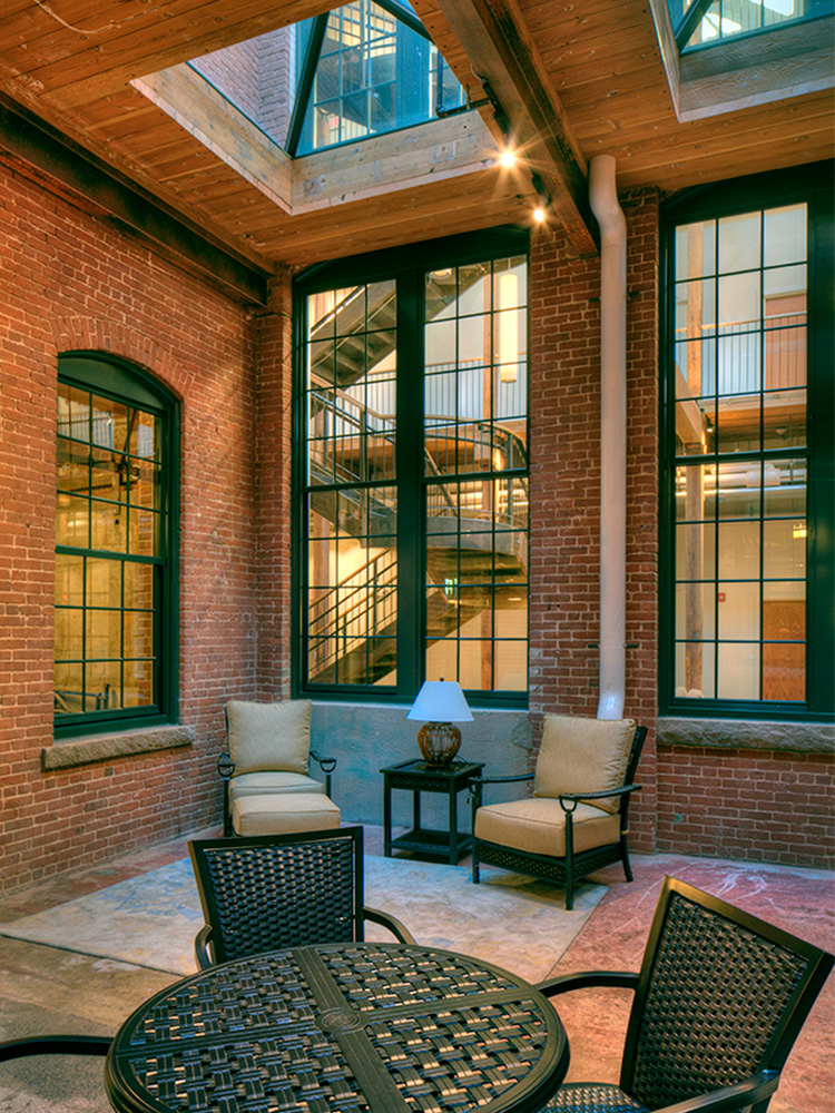 Indoor Patio with wooden ceiling and metal seating and tables 