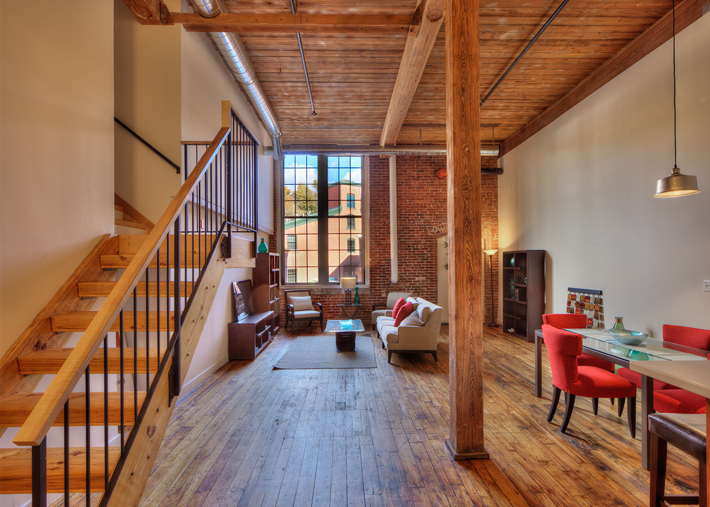 stairwell next to living area, with tall French-style windows 