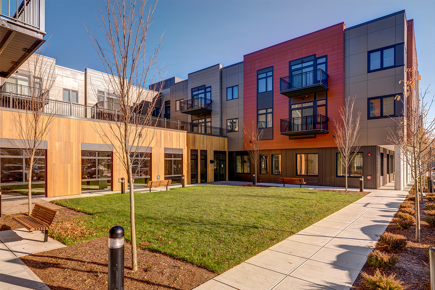 Grass courtyard beside building and sidewalk