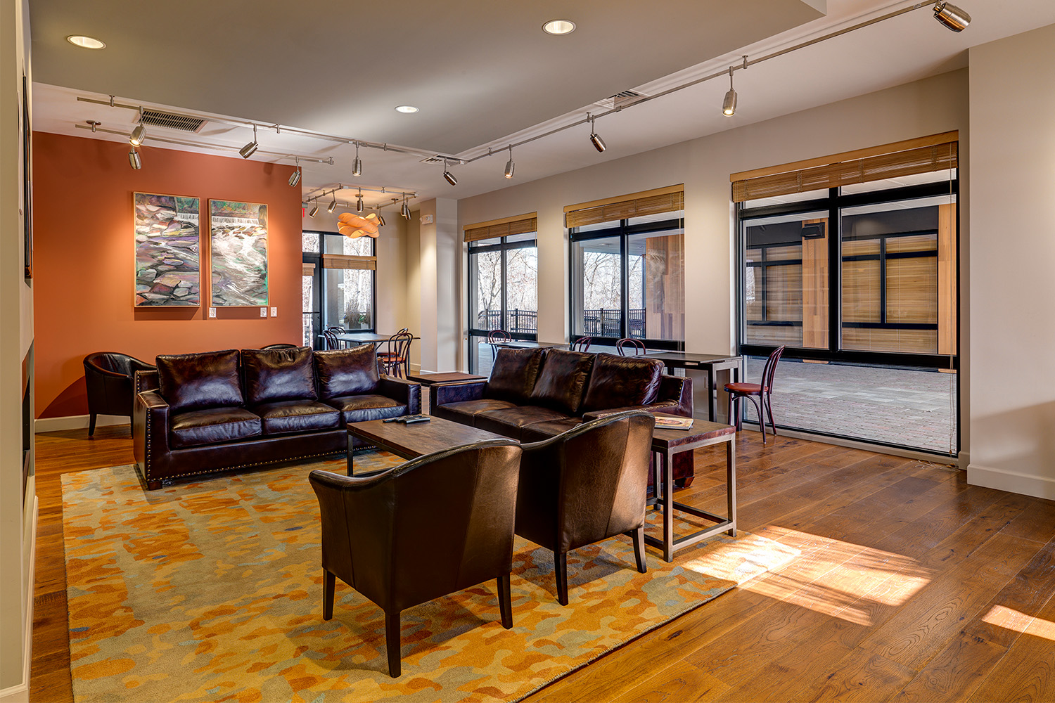 Lobby area with black leather chairs and wall art