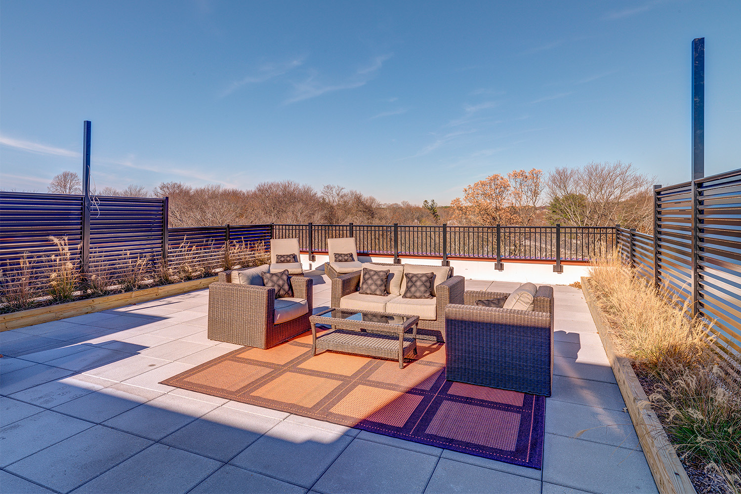 Roof deck with grey tiling and couches 