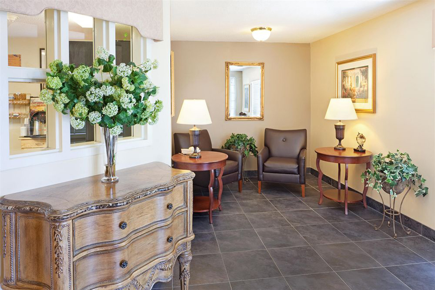 lobby area with wooden dresser and 2 lamps 