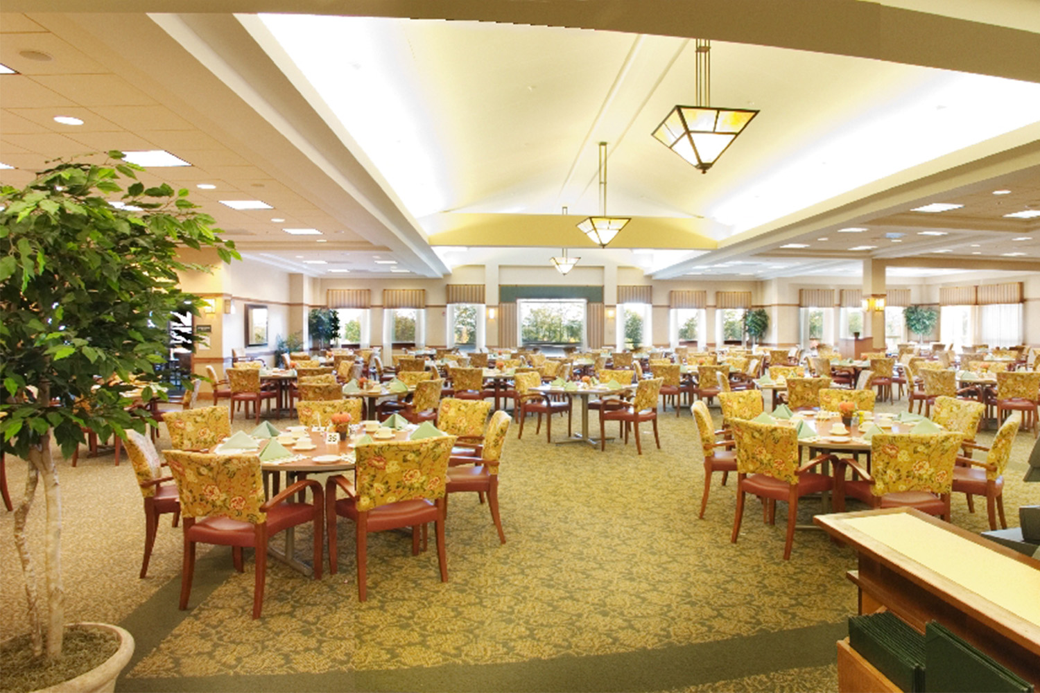 Elegant ballroom dining area, with floral pattern chairs 