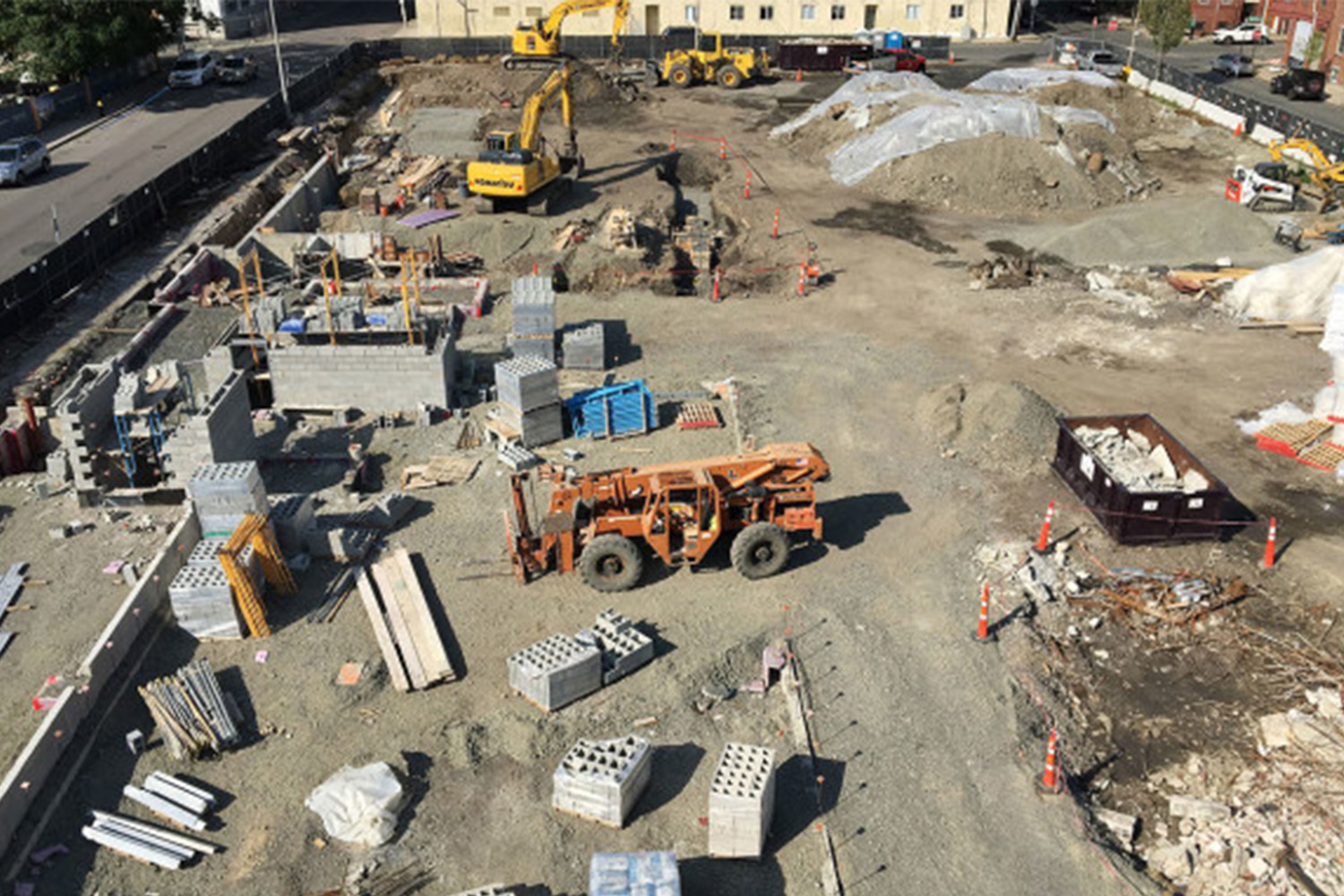 Drone view of construction area with building matierials in several piles