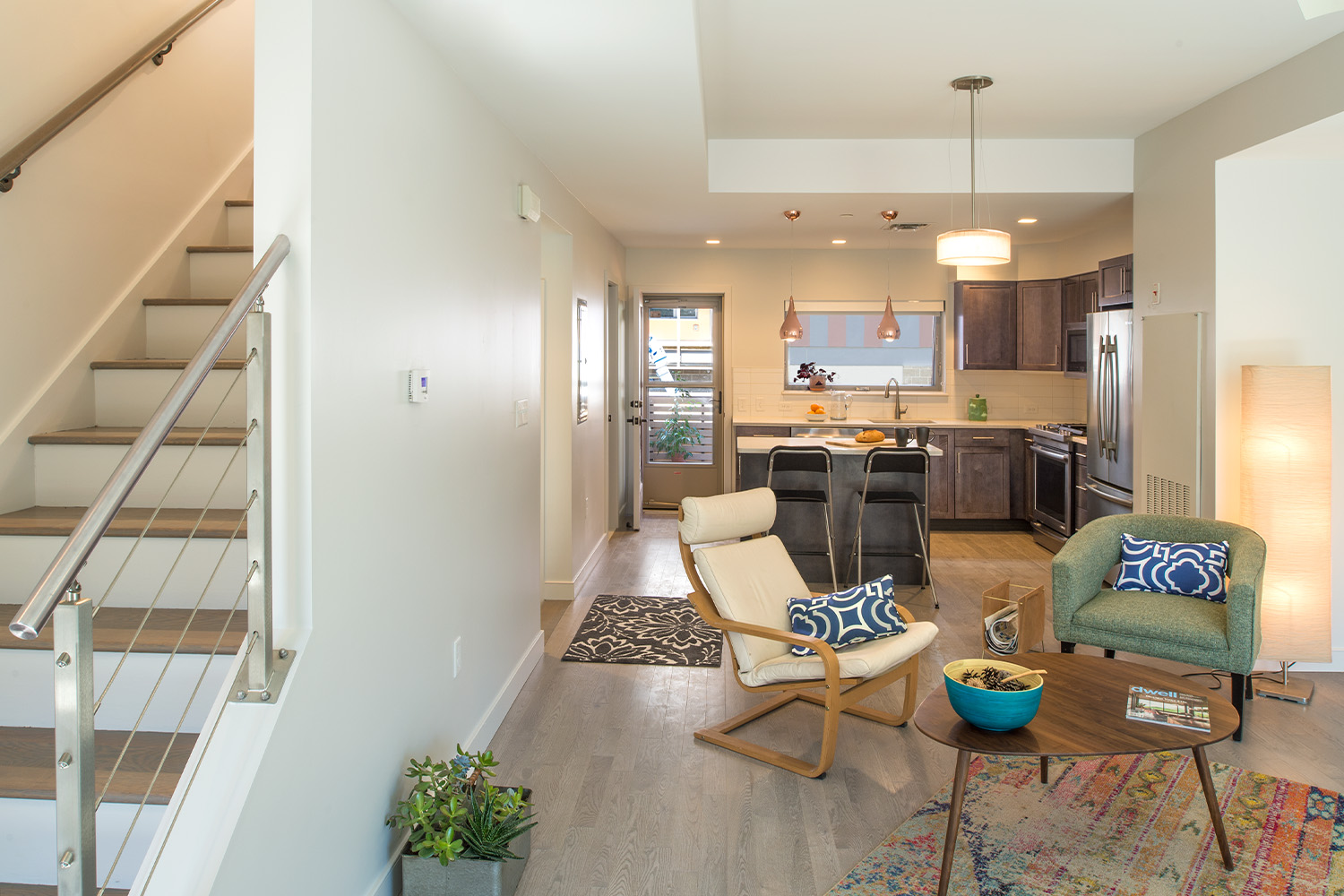 View of living room besides white staircase