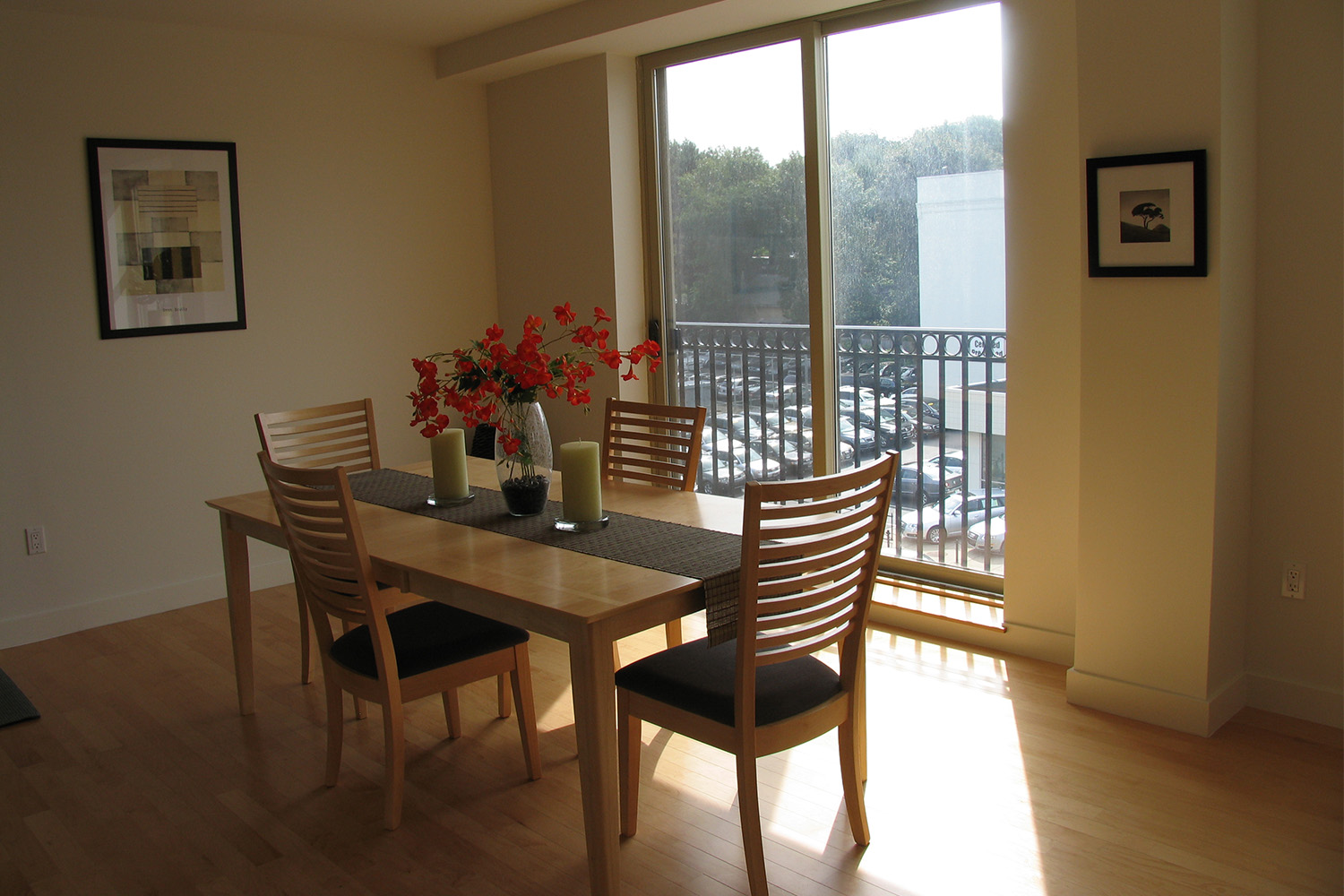 Wooden dining table and chairs next to balcony 