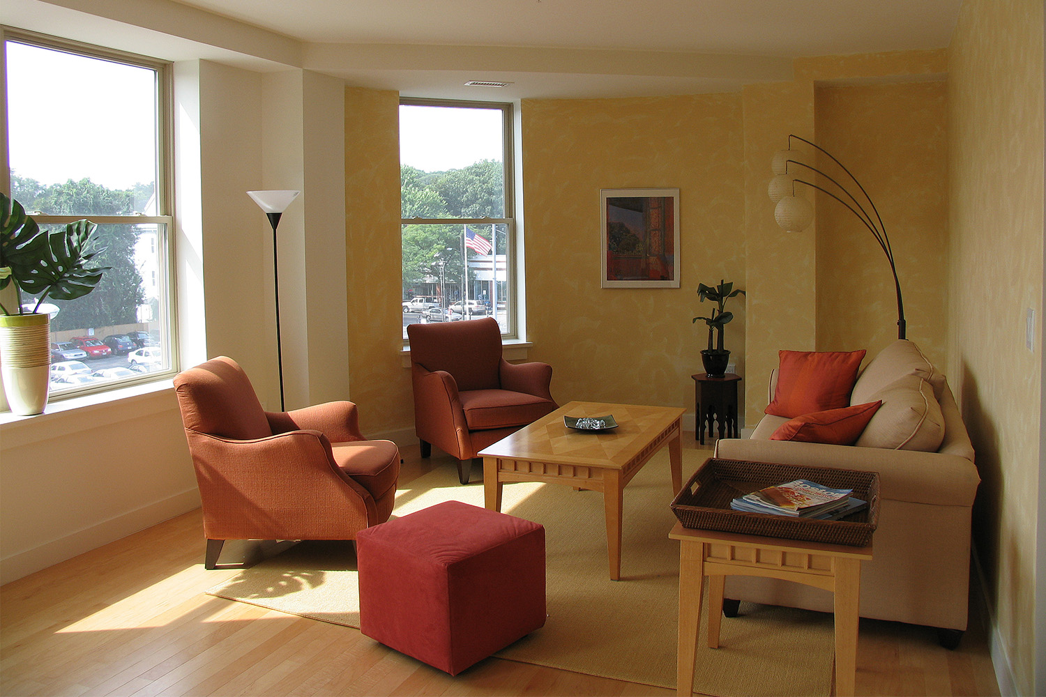 Living room with orange chairs and cream couch 