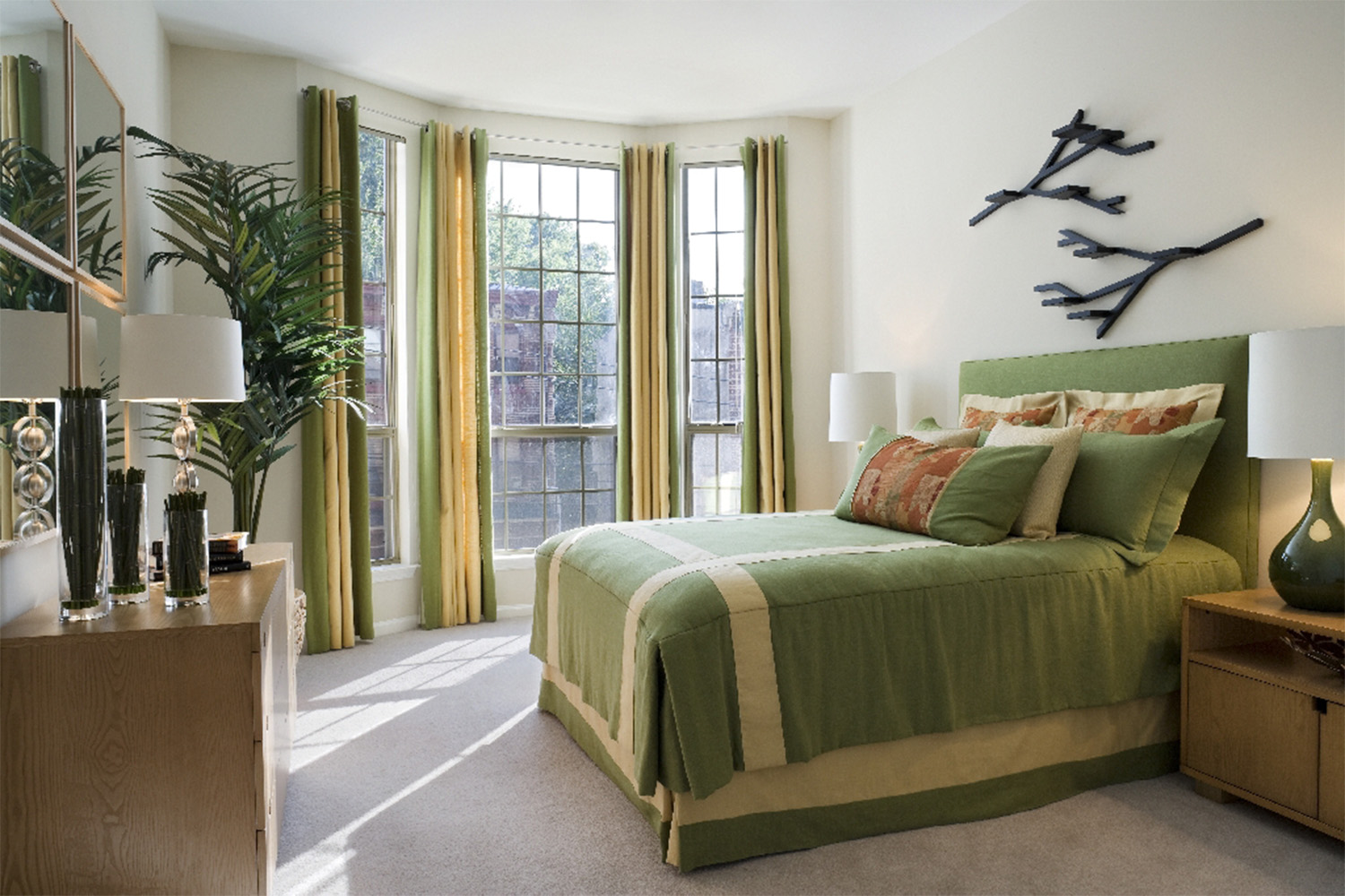 Bright bedroom with plush bed and large curved window 