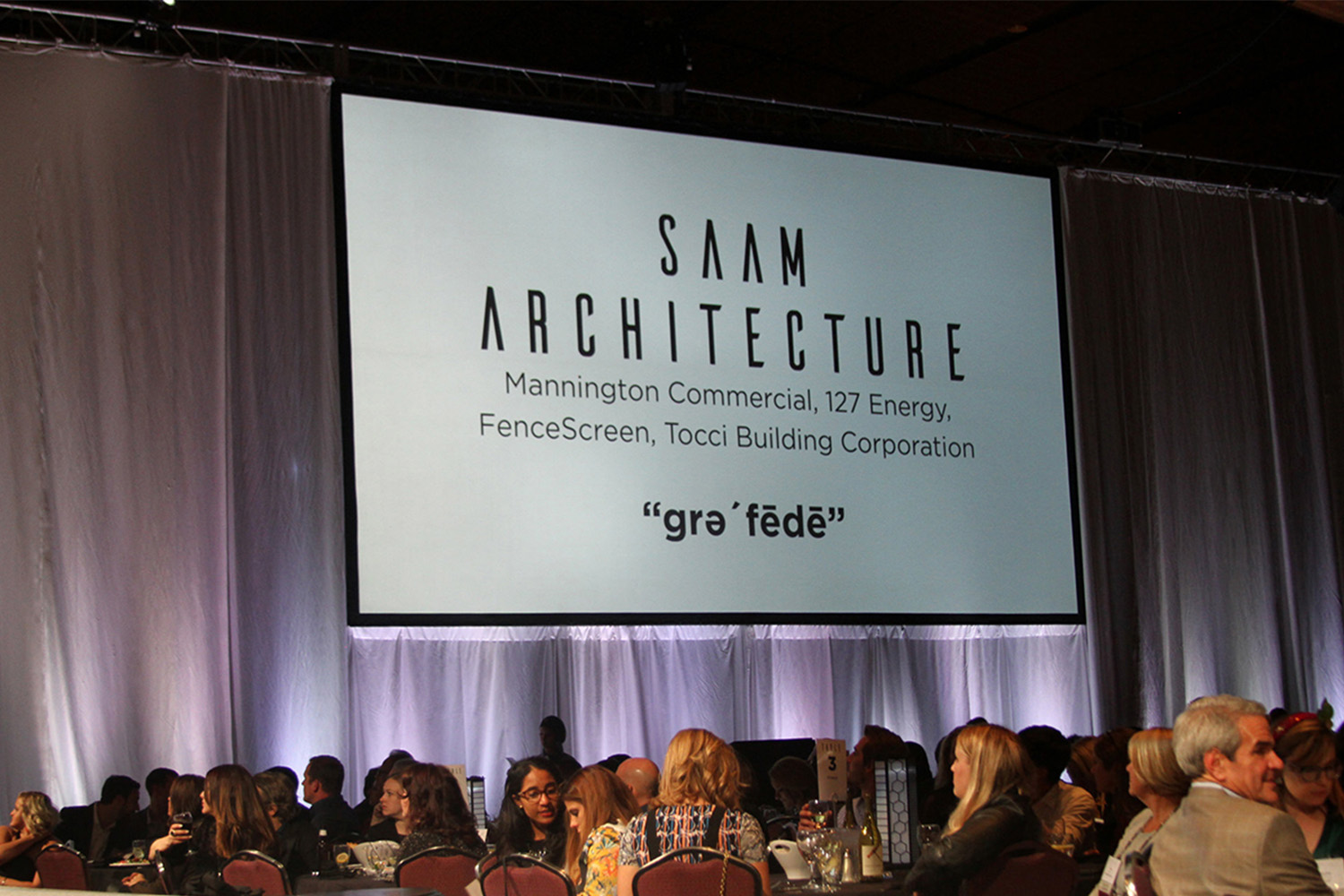 Projecter saying "SAAM Architecture" with corporate participants listed underneath 

