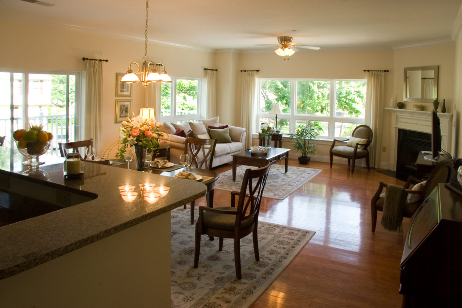 Dining room and living room with chandelier light fixture and fireplace