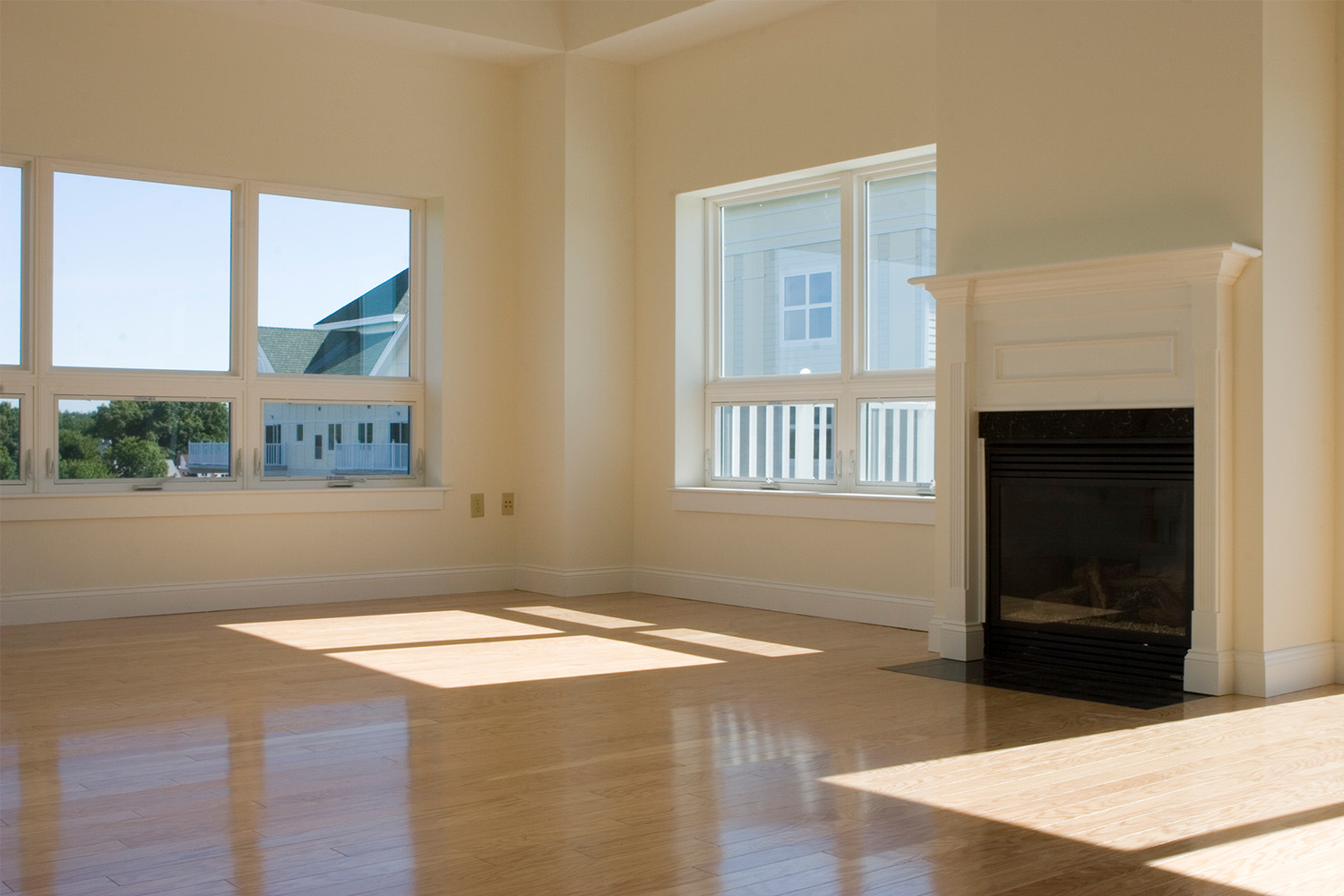 Spacious living area with fireplace, and large modern windows