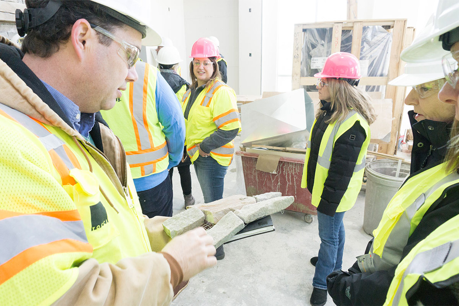 Copnstruction workers looking at several samples of concrete 