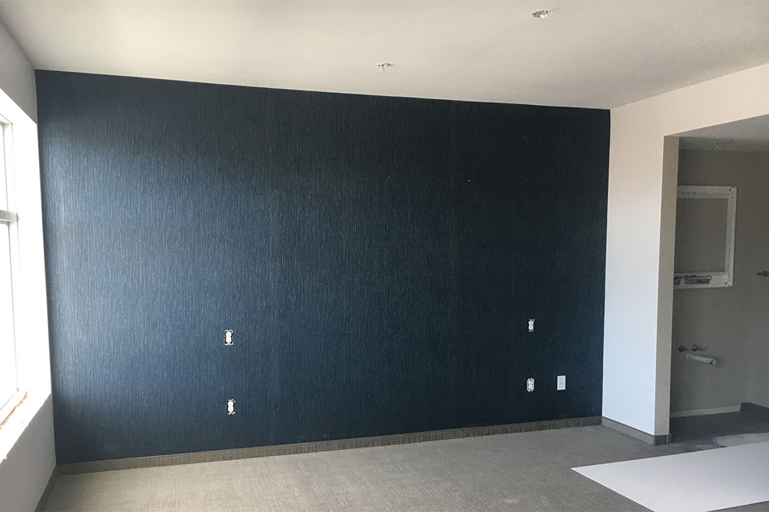 spacious room with single black wall