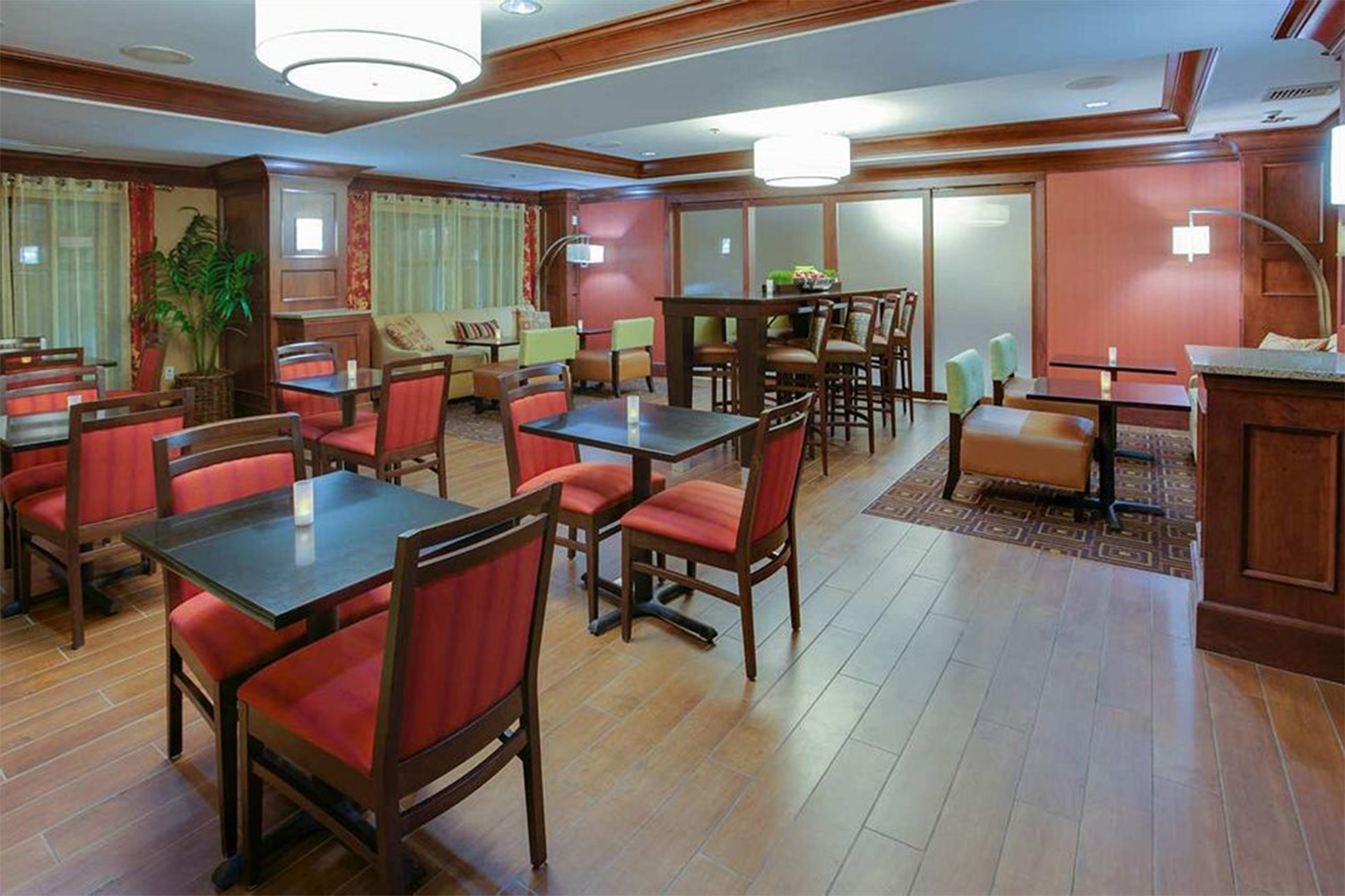 Café area with red seats and dark wood floor 