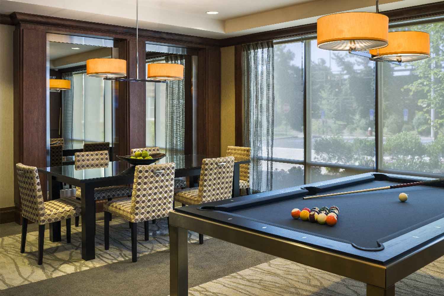 Lounge area with pool table and table with seating 