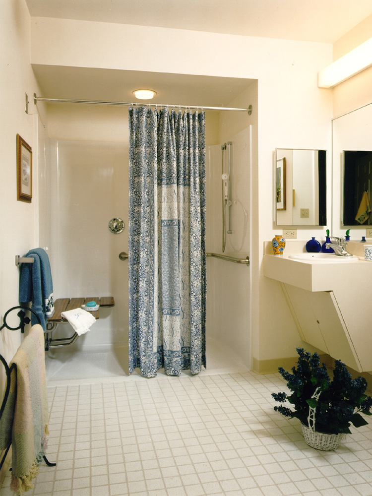 Stark white bathroom with sink, and stand-in shower 