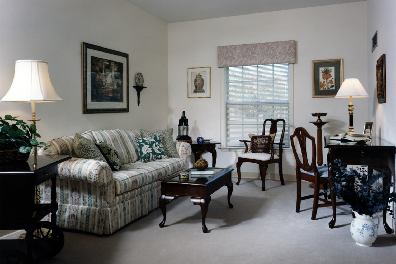 Living room with 1 window, couch, desk, and table 