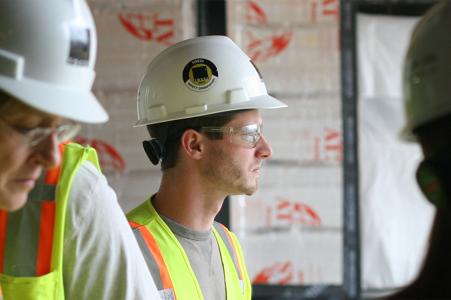 2 interns looking to the left on a construction site