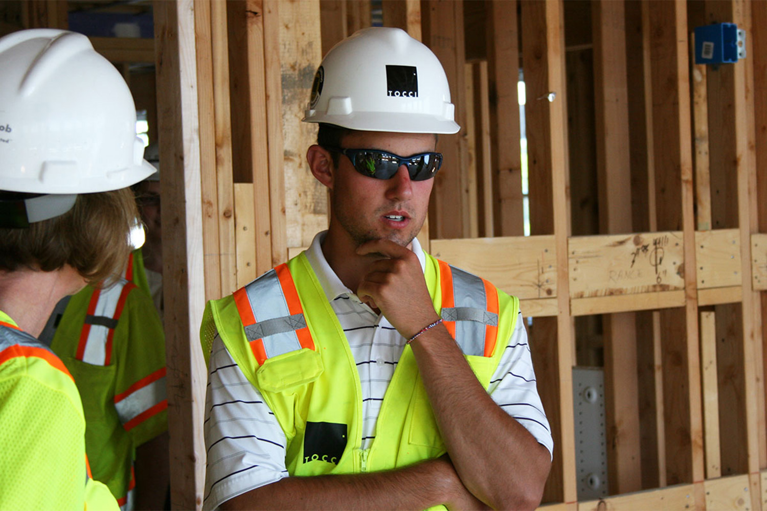 Intern pondering at a construction site