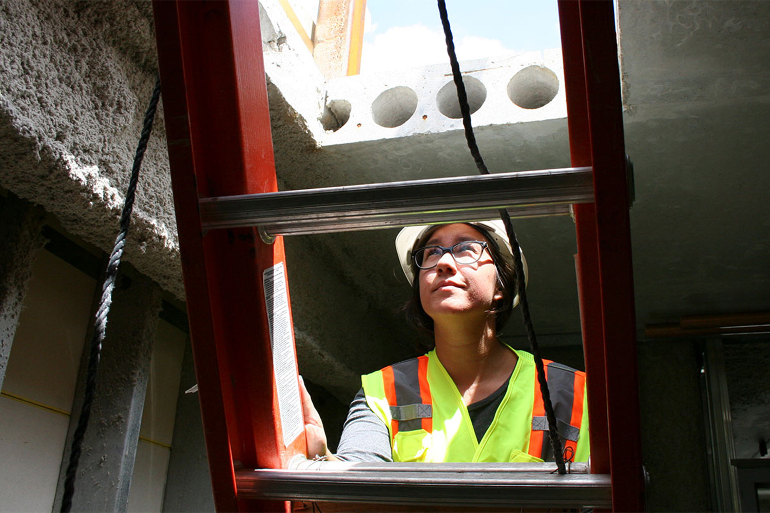 Intern climbing up ladder