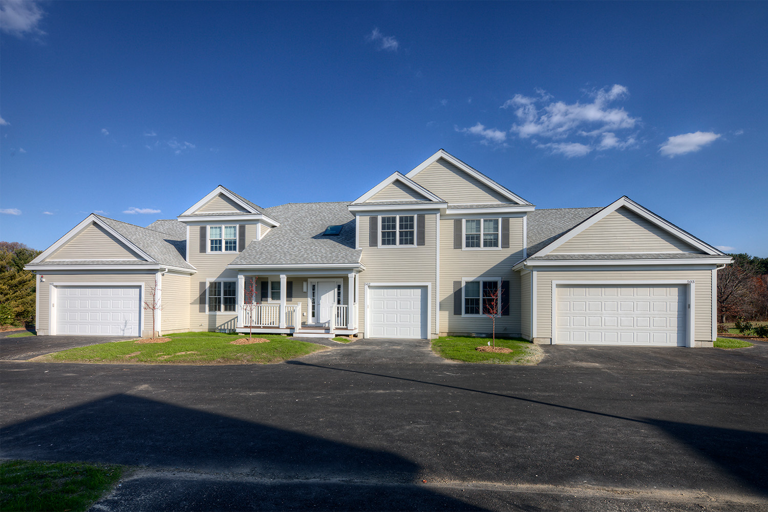 Front exterior of townhouse in summer day