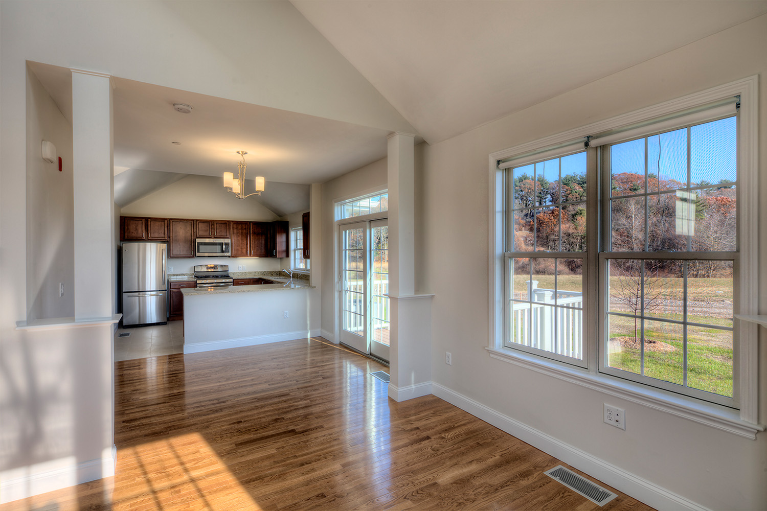 Kitchen with wooden floors and large refrigerator 