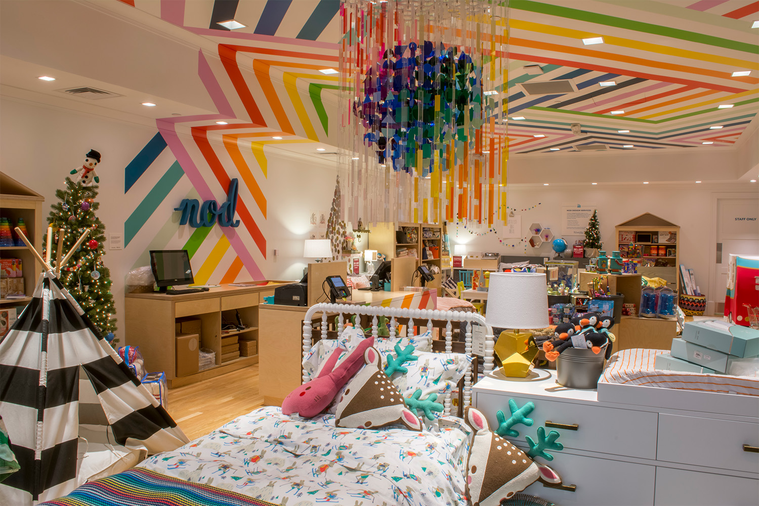 Store merchandise, and a large colorful chandelier hanging from trendy painted ceiling