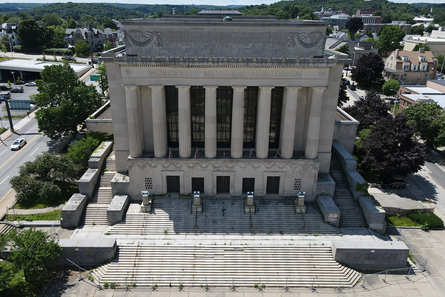 Front view of the once-grand Memorial Auditorium, with a grand staircase leading to the main doors