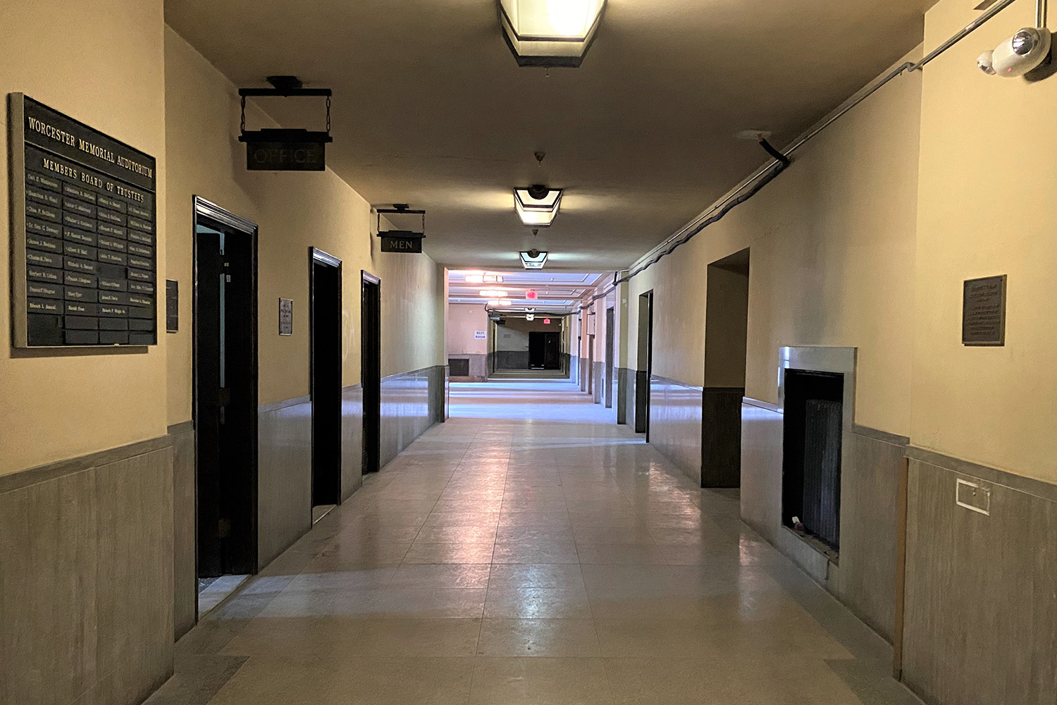 Lit hallway on the first floor of the Memorial Auditorium, still featuring original fixtures and signage before the Auditorium closed its doors