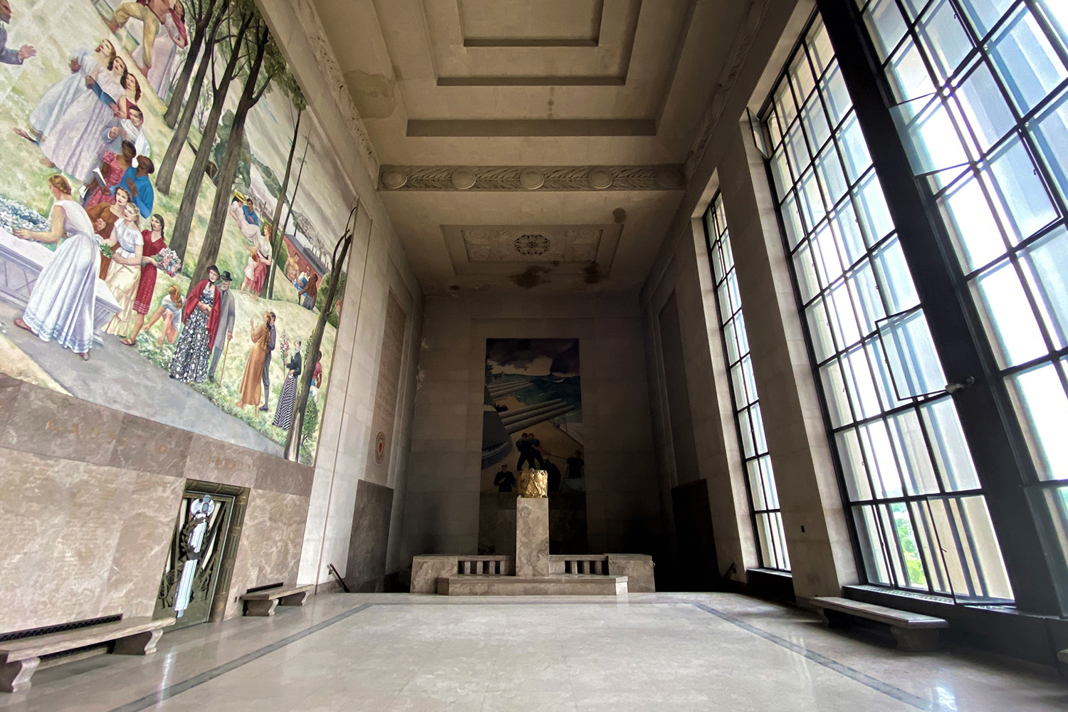 Memorial Auditorium's atrirum, with large windows to the right and mural on opposite side