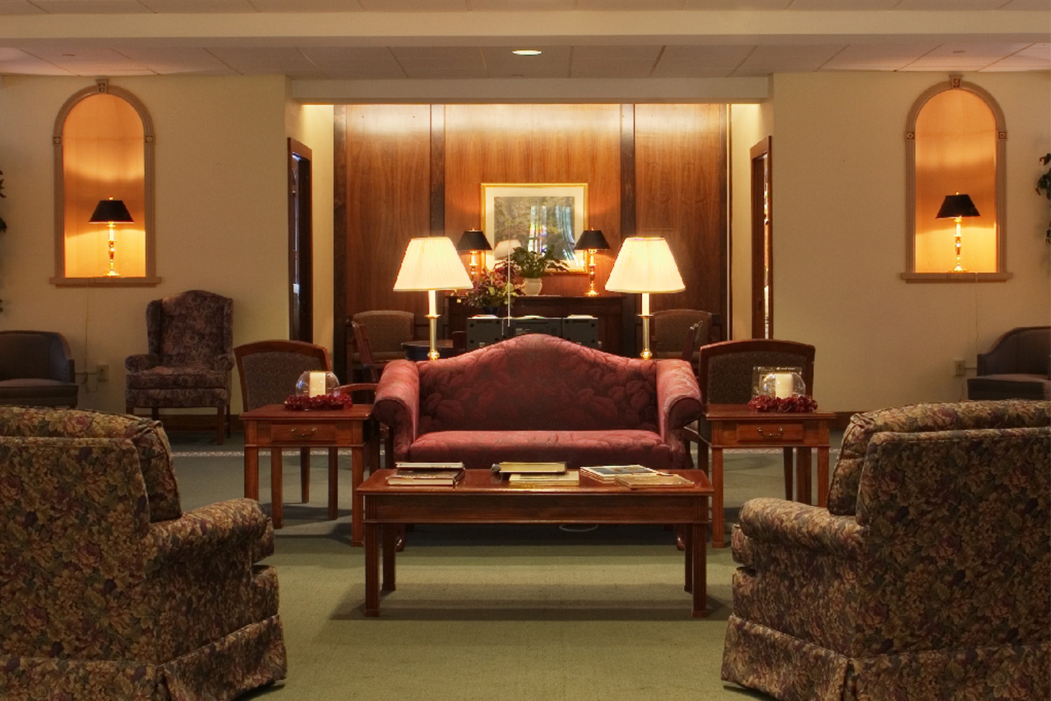 Lobby with red couch and settle lighting 