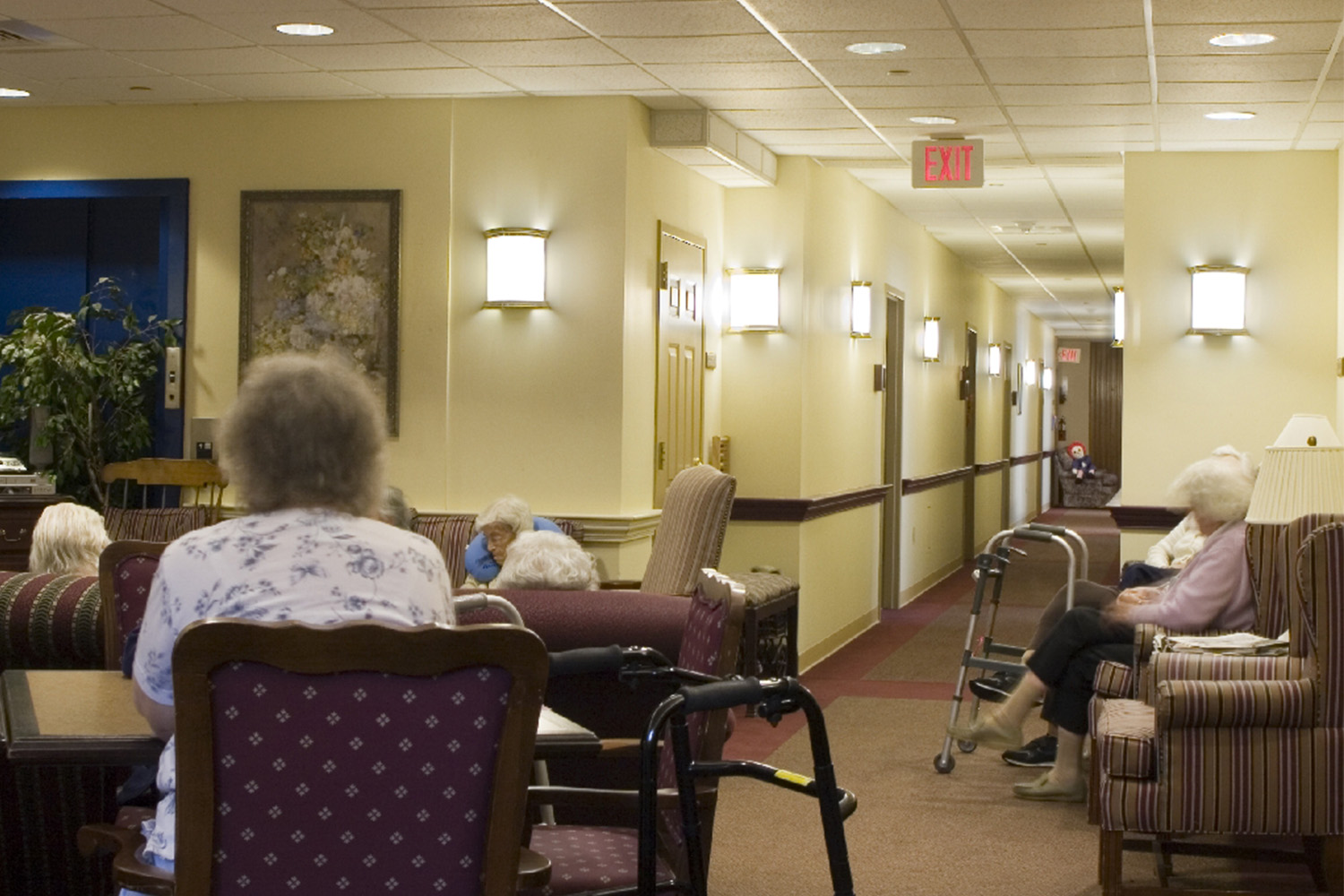 Interior of mental health wing, with ample seating and a hallway 