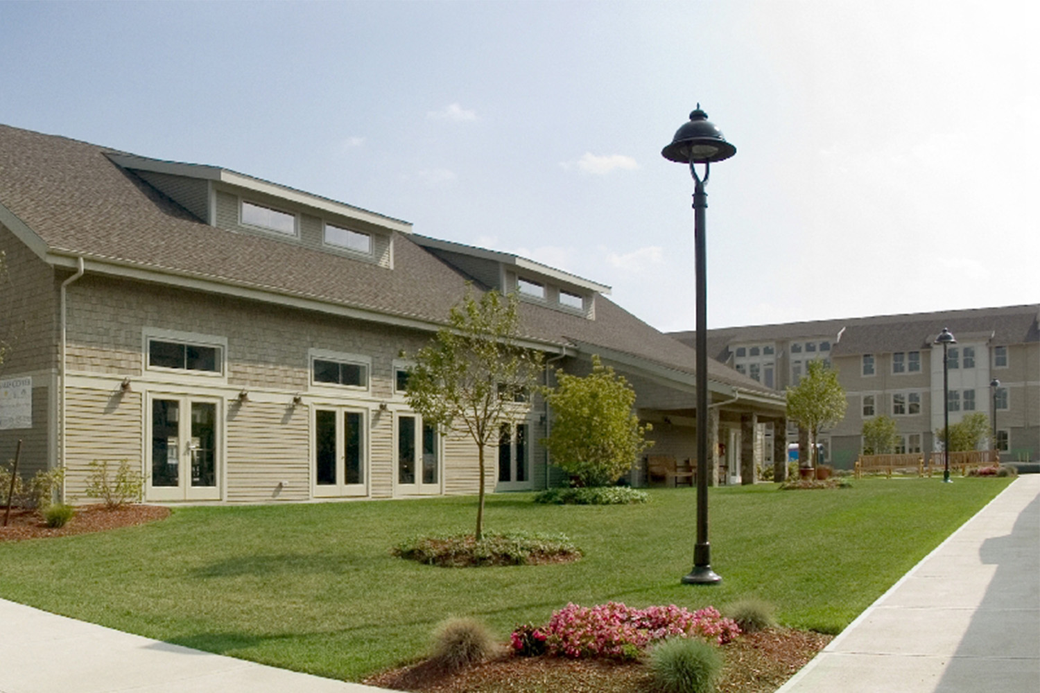 Walkway with black street lamp, next to rows of condos