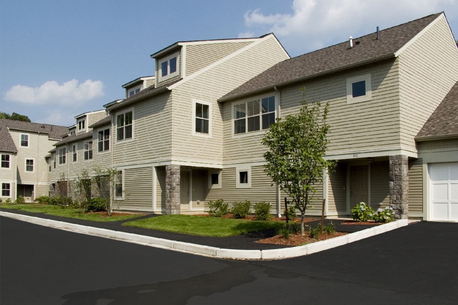 Façade of condos next to freshly paved street