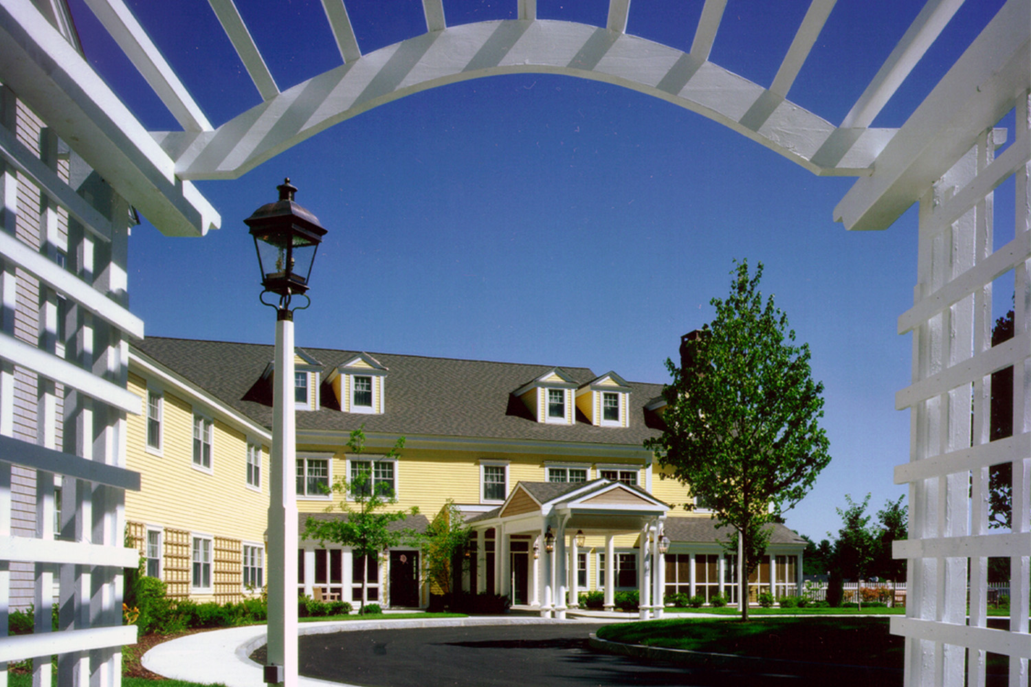 View of exterior as seen from under elegant white gateway