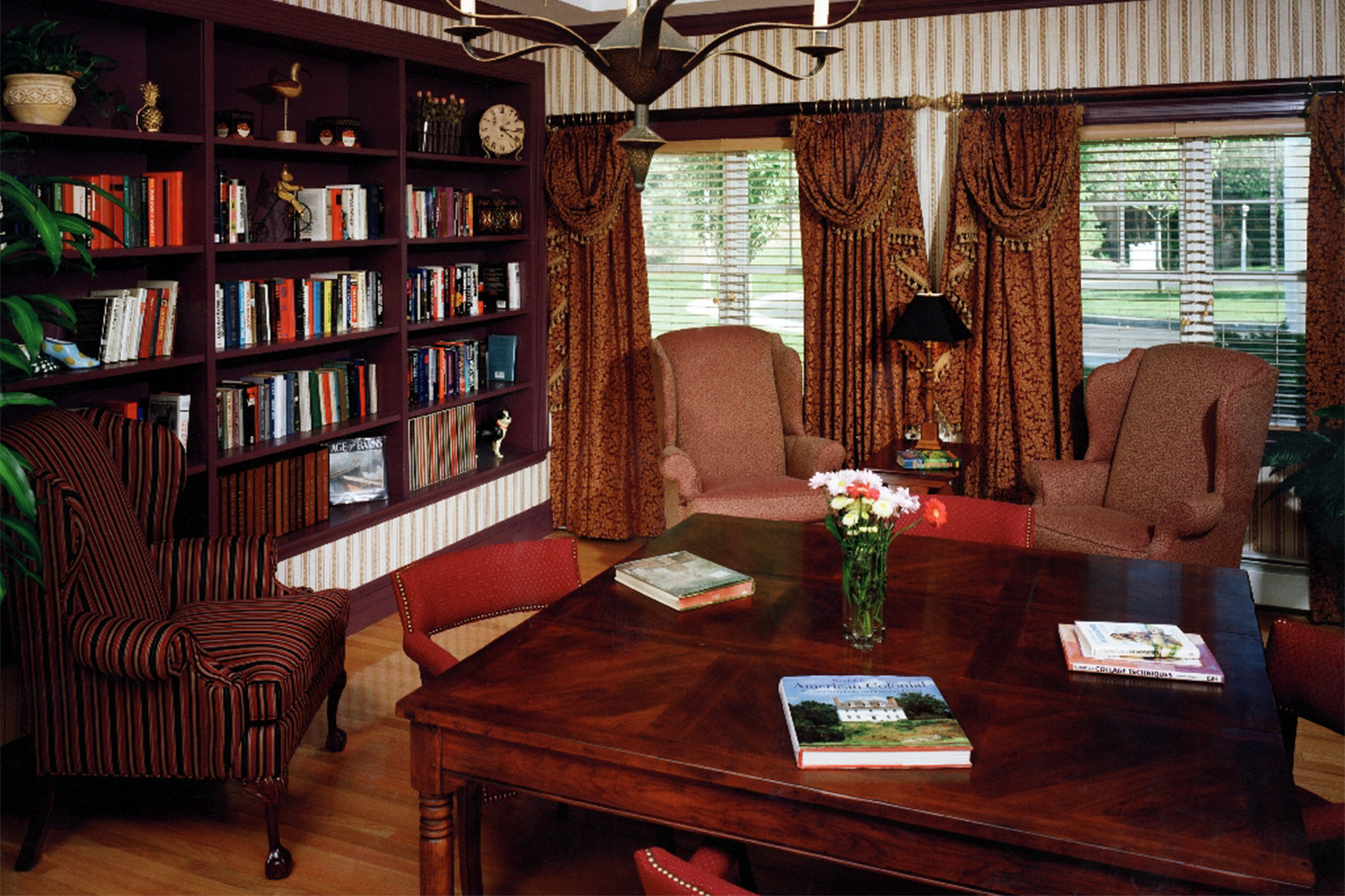 Library with cherrywood table and bookcase, and 2 plush chairs