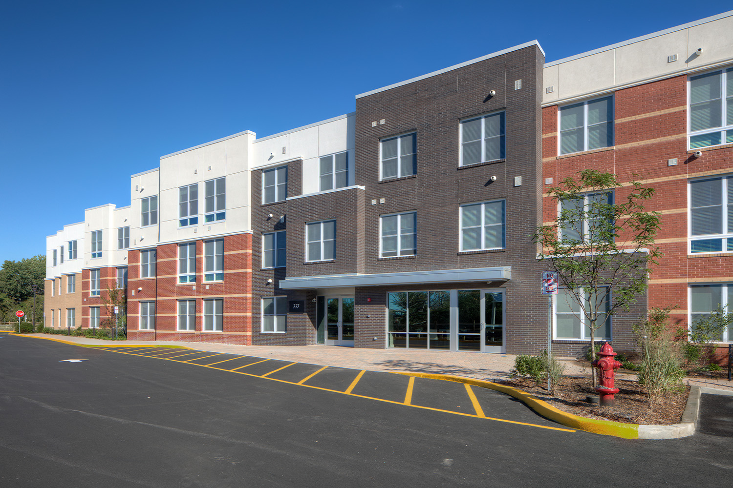 Exterior of Osprey Cove East, with parking lot in front 