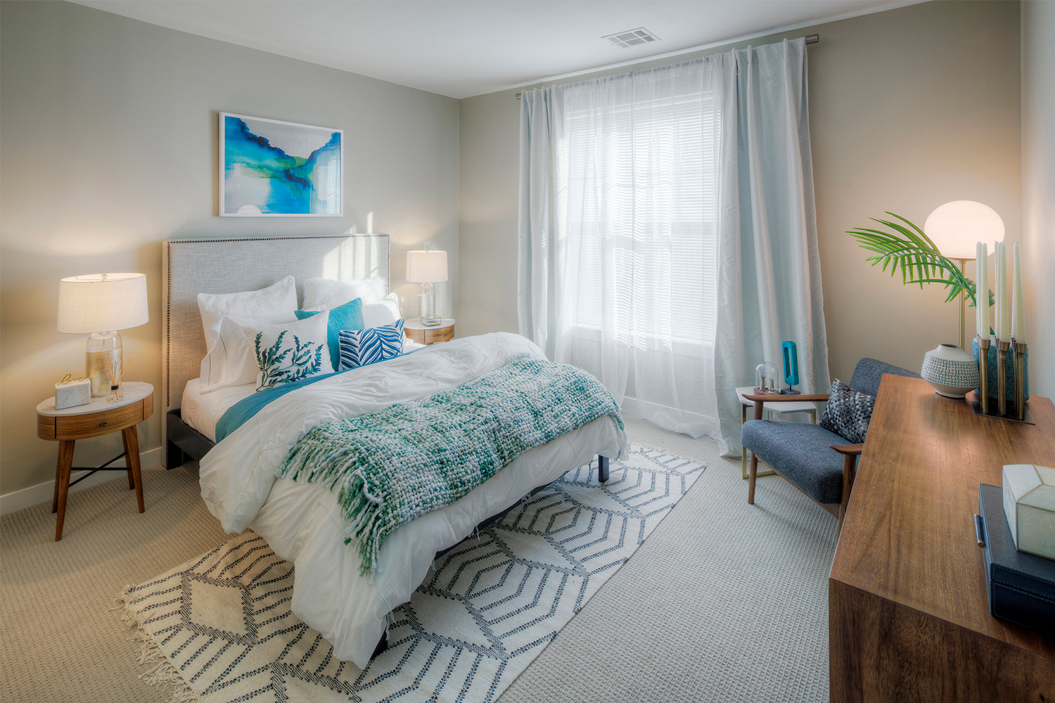 Plush bedroom with light blue details and ambient lighting 