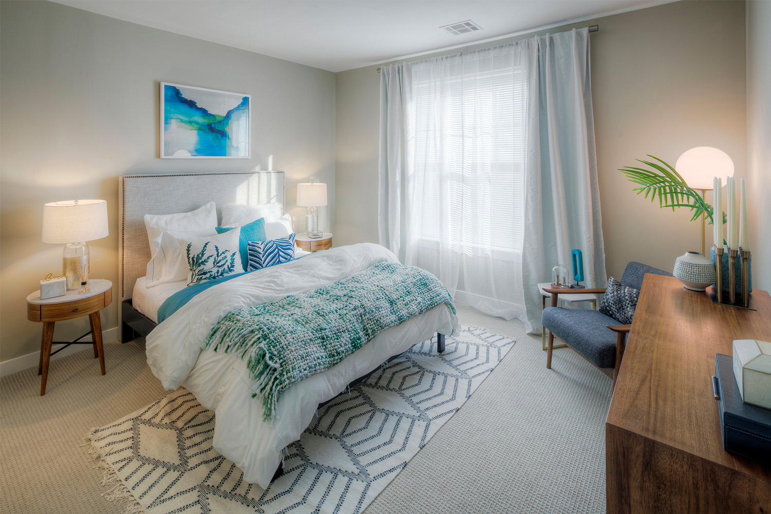 Plush bedroom with light blue details and ambient lighting