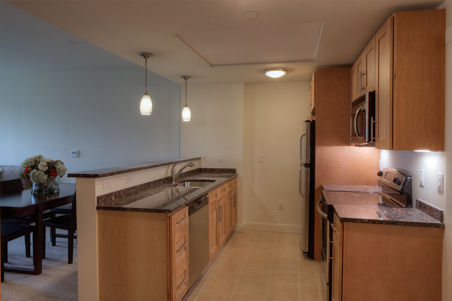 Sideview of kitchen, with maple cabinets and utilities
