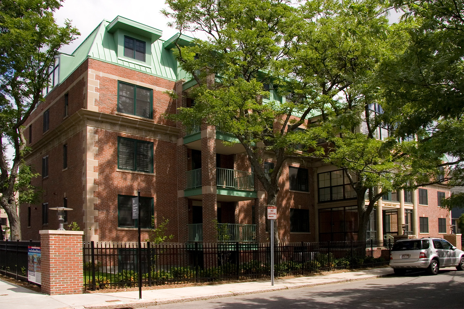 Exterior frontal view, partially covered by tree shade