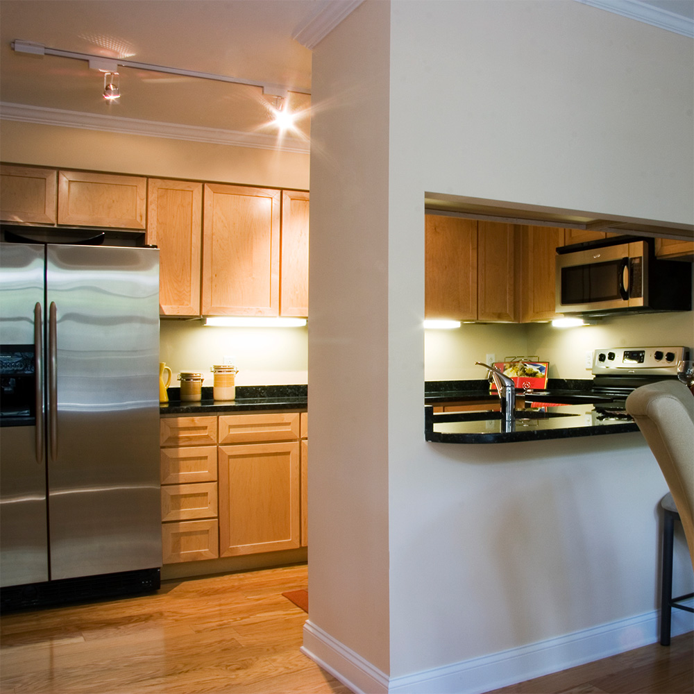 Kitchen with partial wall dividing it from dining room 