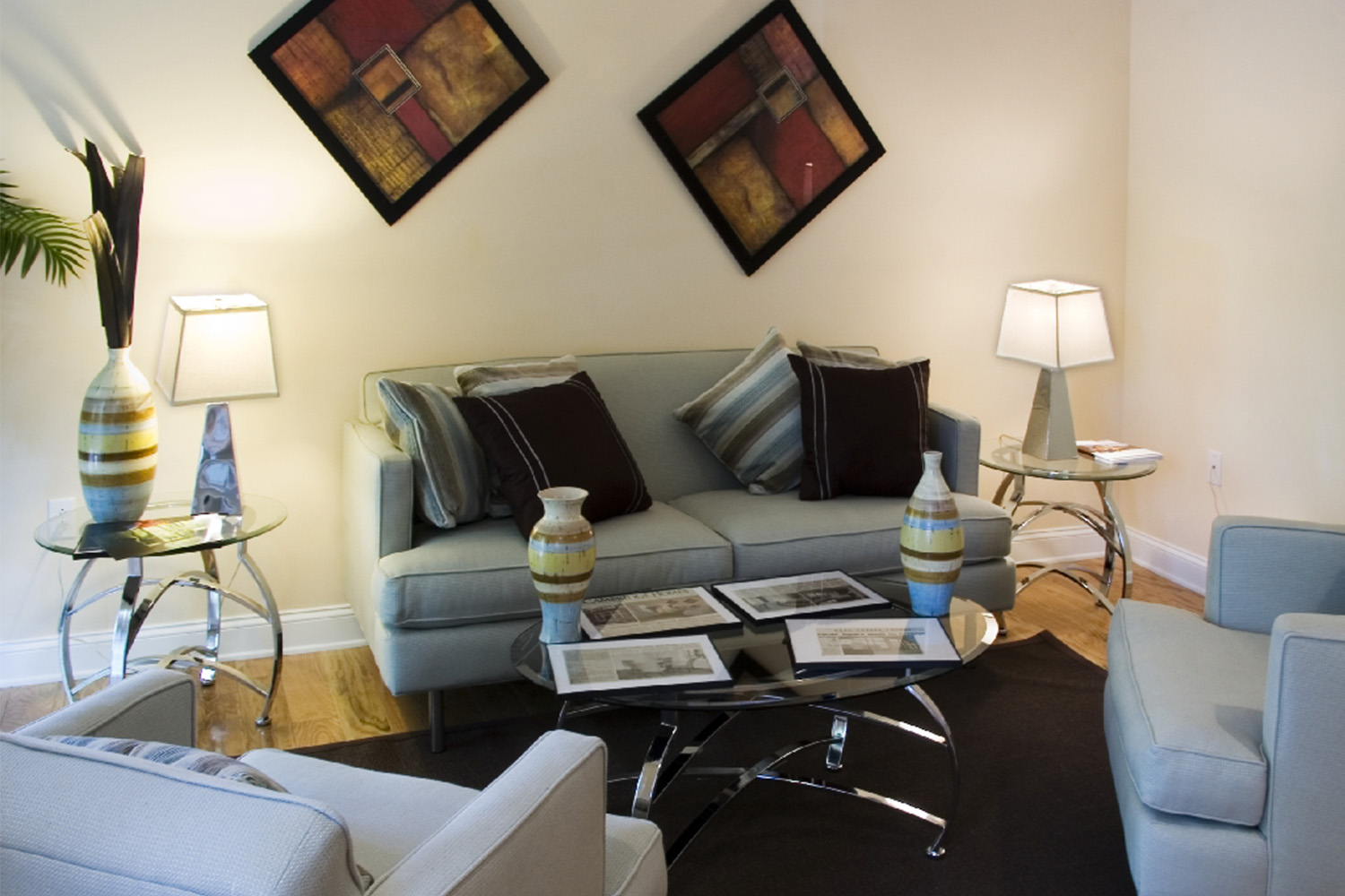 Light blue couch and chairs, and black rug