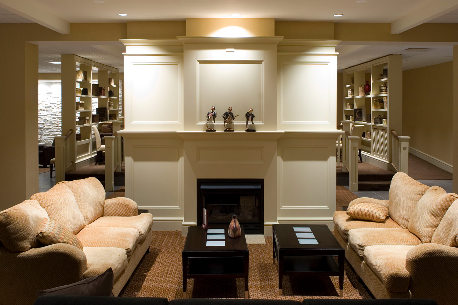 Lounge area with plush tan couches and fireplace 