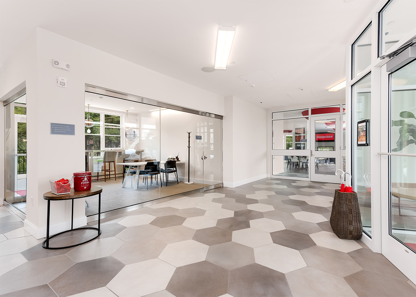 Station Row lobby area with side table and basket 