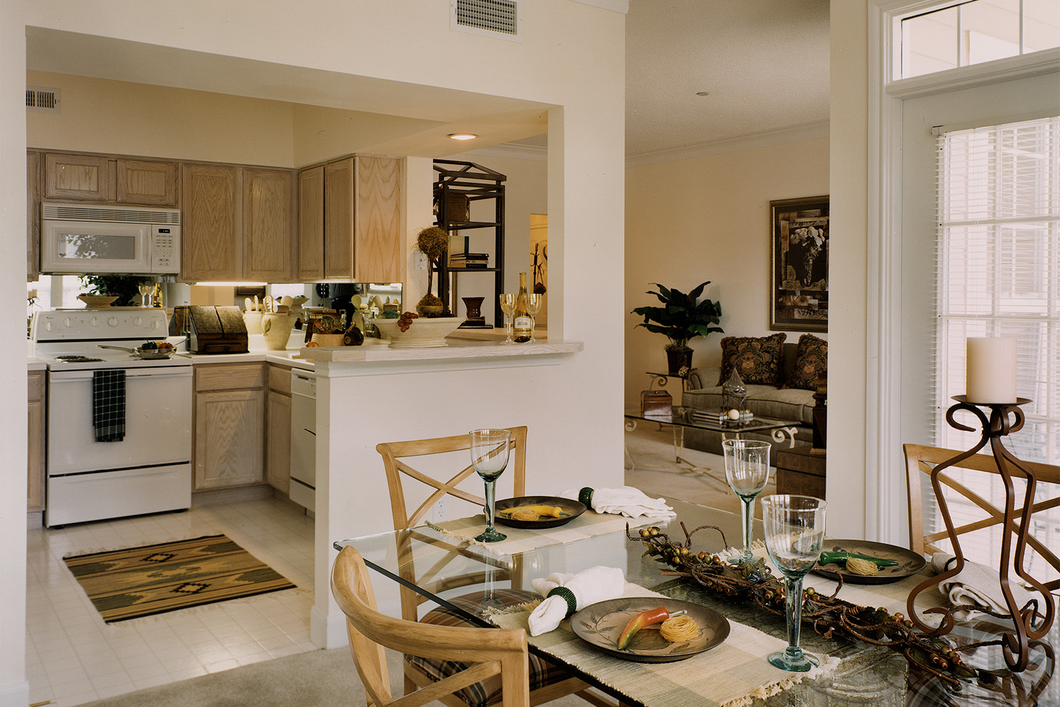 Elegant kitchen with oak cabinets, white stove, and dining area 