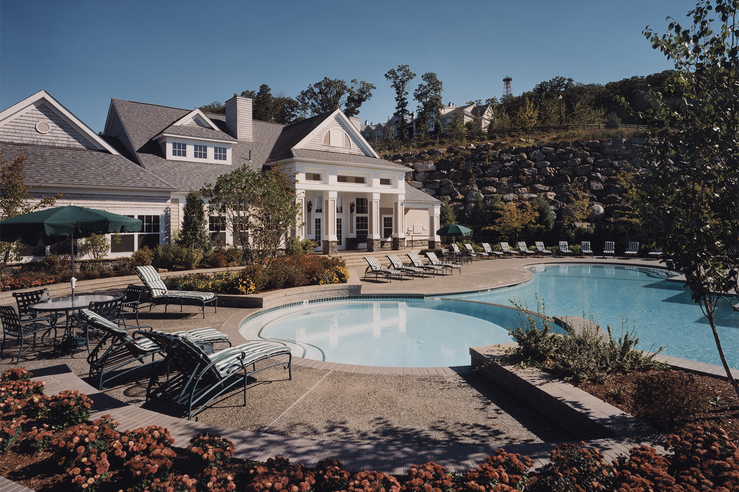 Partial sideview of pool, seen from across flowerbed 