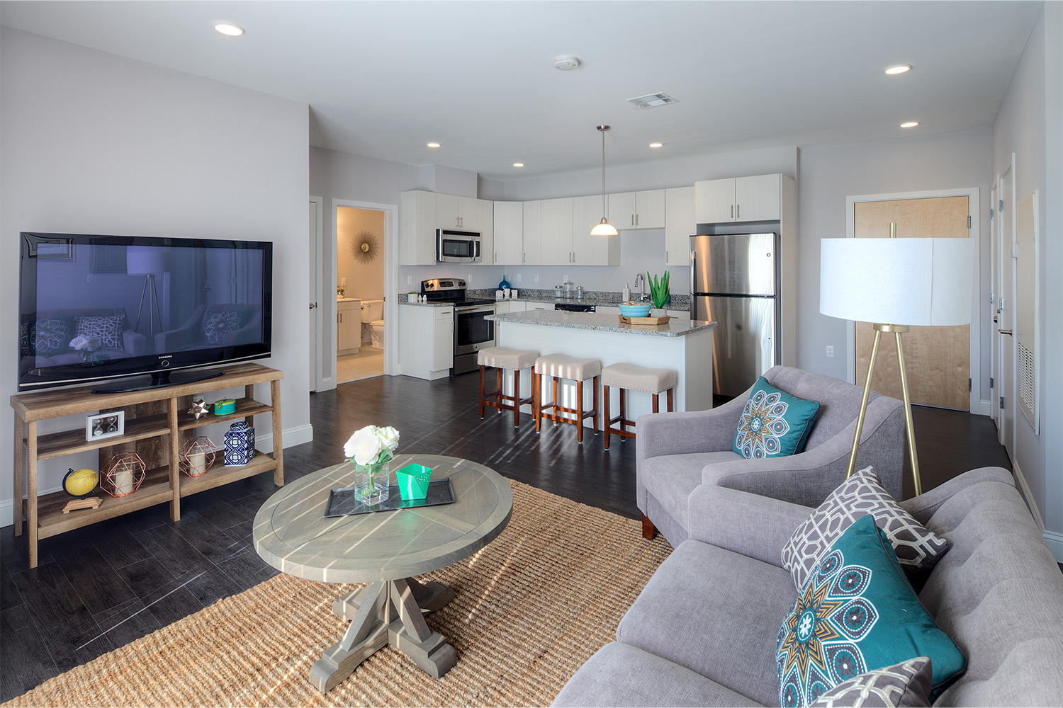 Living room seen from edge of grey couch, in front of TV 